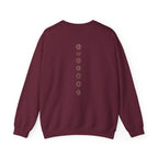 Back of a crewneck showing seven chakra symbols down the spine
