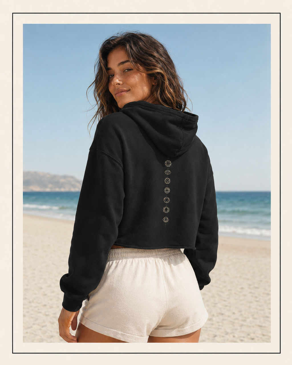 Back of a crop hoodie showing seven chakra symbols down the spine