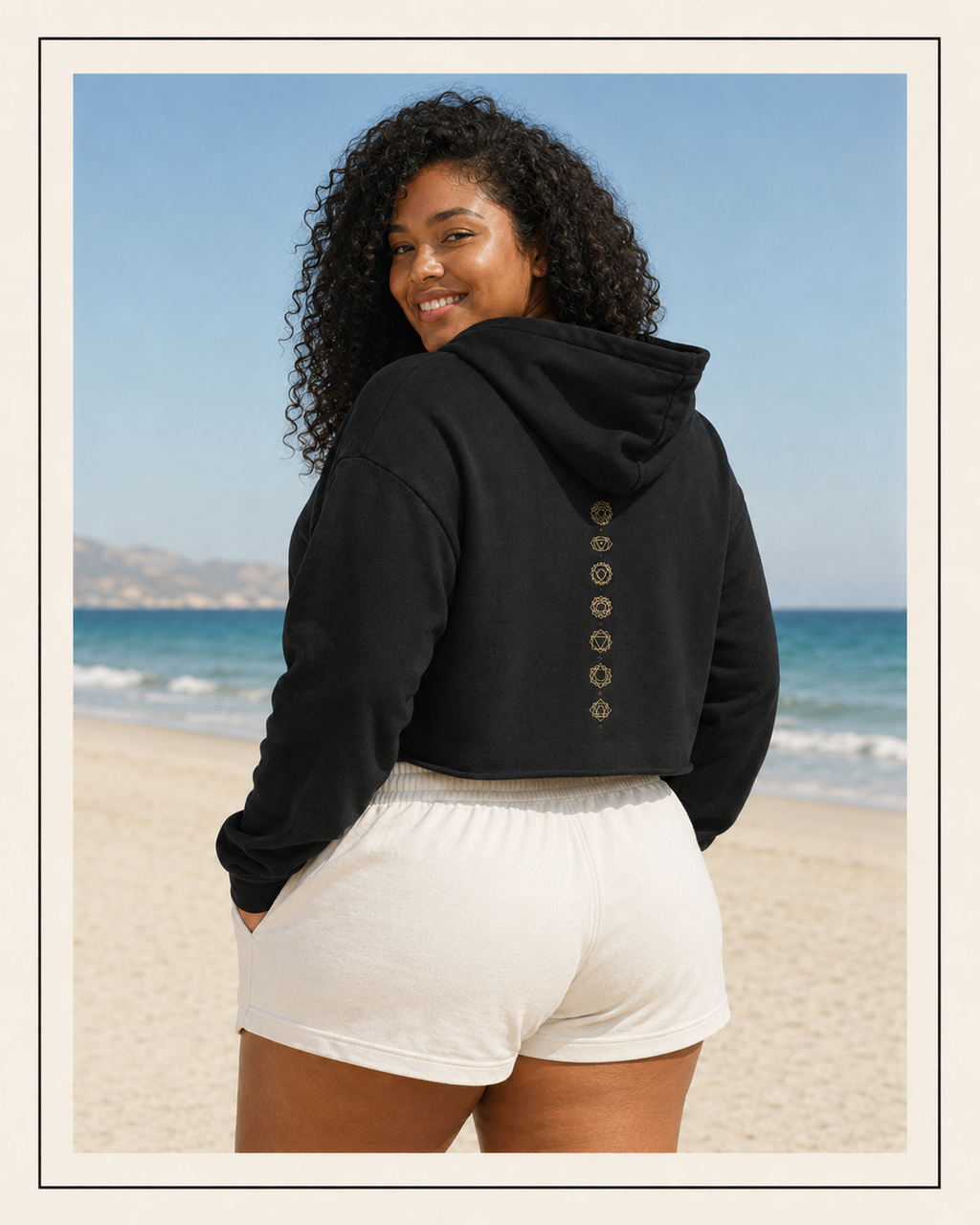 Back of a crop hoodie showing seven chakra symbols down the spine