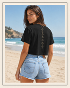 Back of a crop tee showing seven chakra symbols down the spine