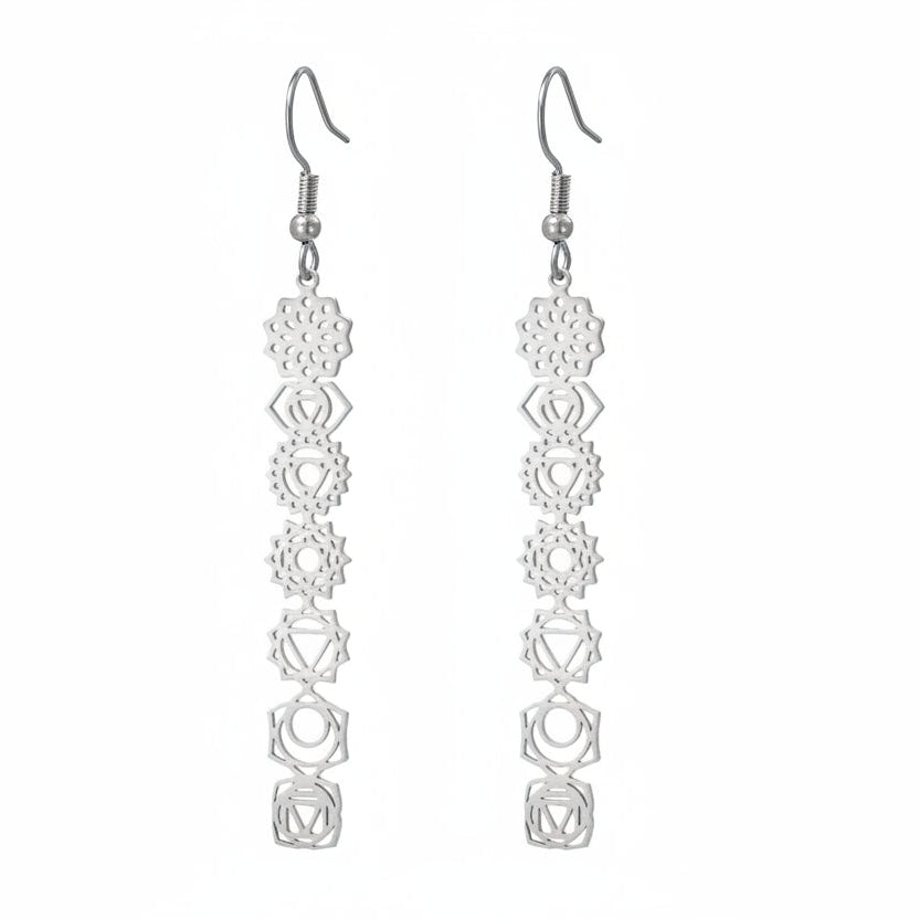 Pair of silver earrings with geometric design on a white background