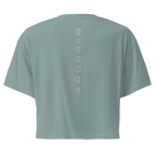 Back of a crop tee showing seven chakra symbols down the spine